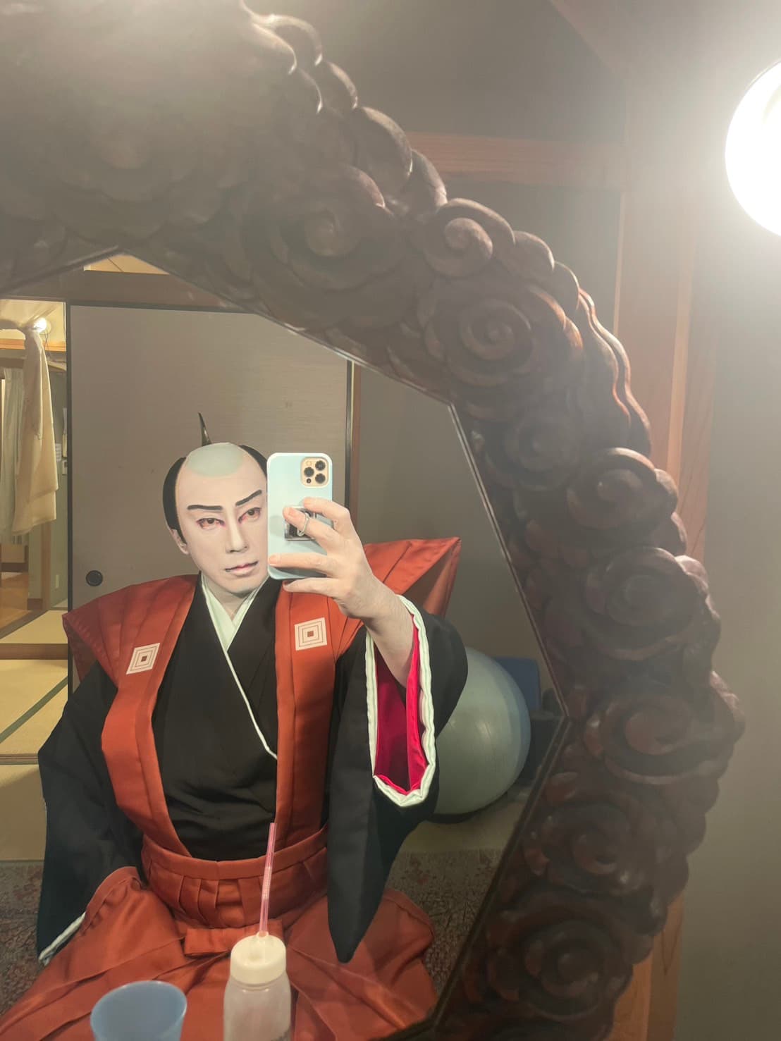 In red formal costume before the mirror